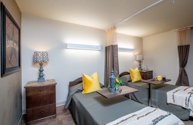 Bright, inviting shared bedroom with decor for residents