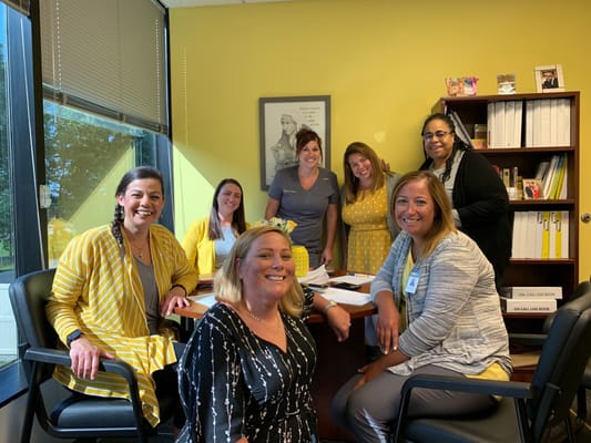 A group of staff members in a bright office setting
