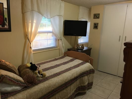 Cozy resident room with a bed and television