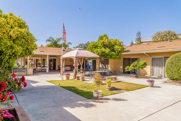 Outdoor courtyard with gazebo and seating area at Redlands Healthcare Center