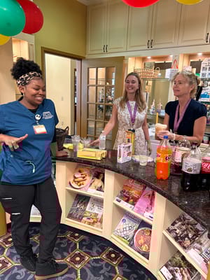 Staff members engaging with each other at a social event