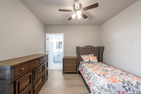 Spacious bedroom with a bed and dresser