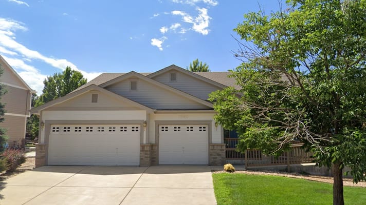 Exterior view of a senior living facility with grassy area