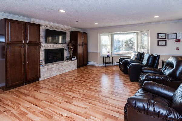 Cozy common area with leather recliners and warm lighting