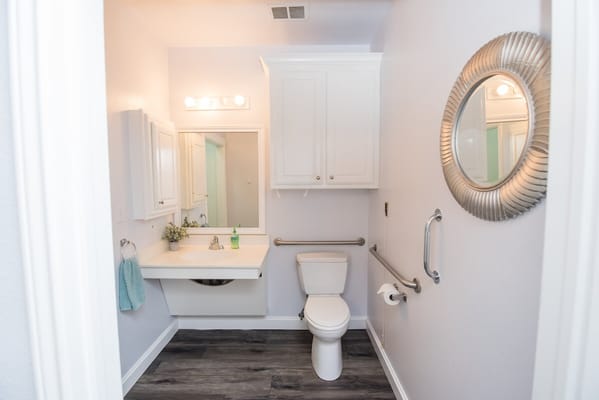 Spacious bathroom with modern fixtures and grab bars