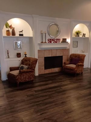 Comfortable chairs in a well-decorated living room with a fireplace