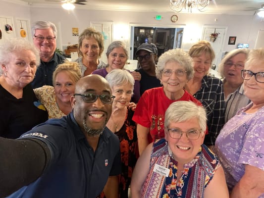 Group of residents and staff posing happily together