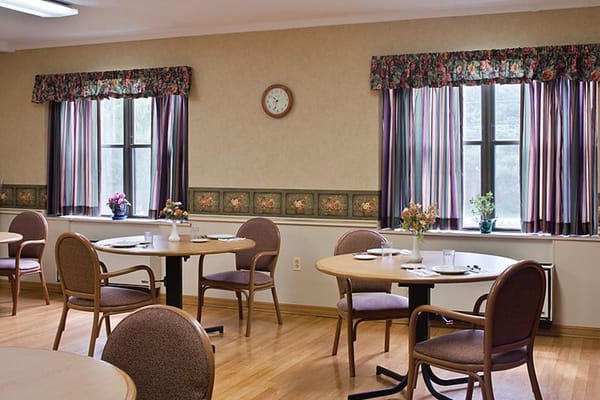 Dining area with tables and floral curtains