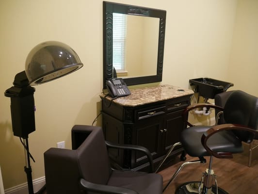 Salon area with stylist chairs and hairdryer.