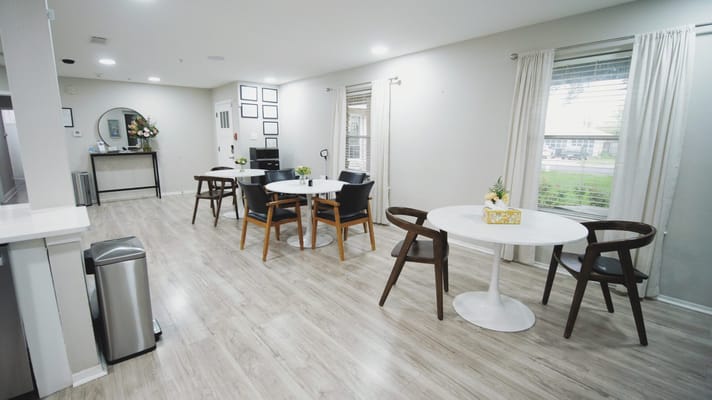 Bright common area with tables and chairs at Silverleaf Eldercare.