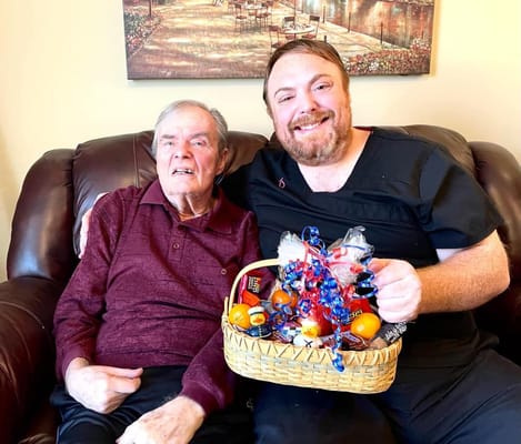 Staff member with a resident sharing a gift basket