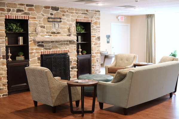 Lounge area with comfortable seating and stone wall decor