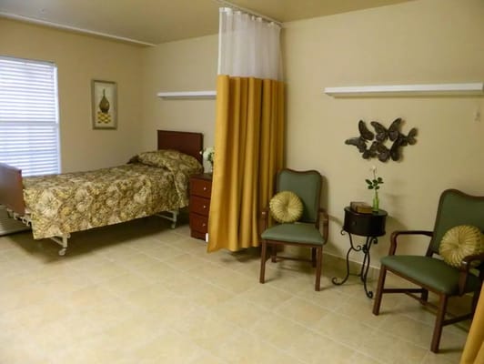 Cozy bedroom featuring a bed, chairs, and decorative elements