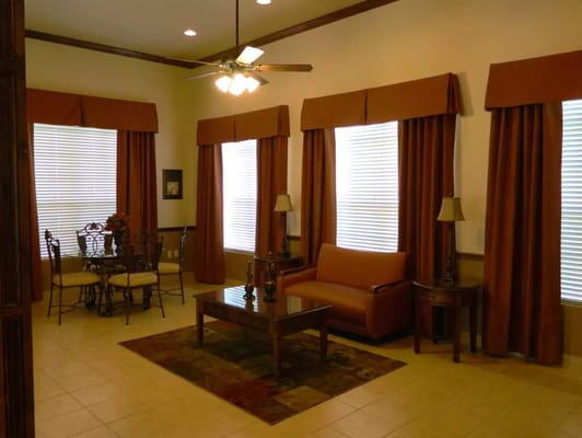 Bright living room with a sofa, table, and dining area