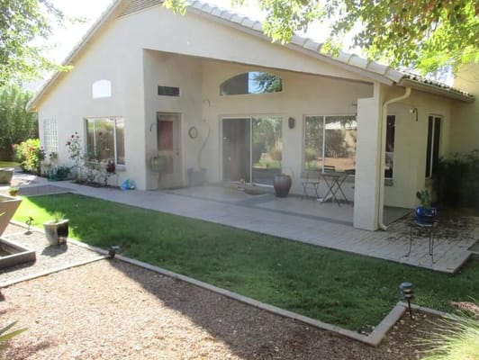 Quiet patio space with chairs and greenery at Southwest Healing Gardens