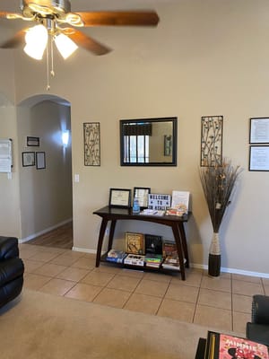 Lobby area with a table displaying books and a sign that reads 'WELCOME TO SW HEALTH'