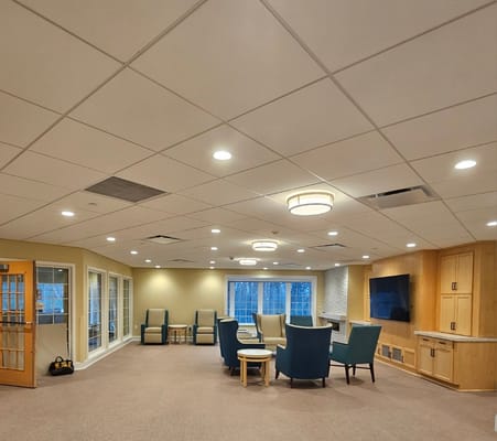 Spacious lounge area with blue chairs and a large window