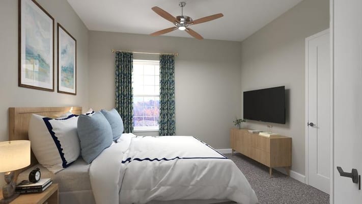Brightly lit bedroom with a bed, TV, and decorative artwork