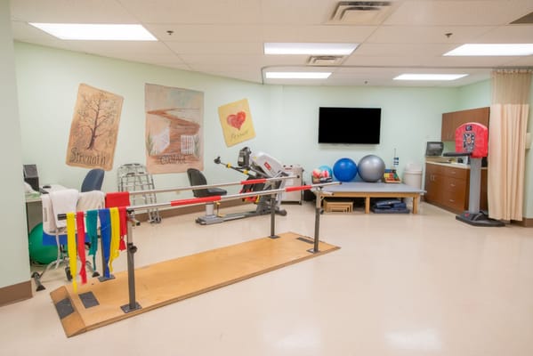 Therapy room featuring exercise equipment and motivational artwork