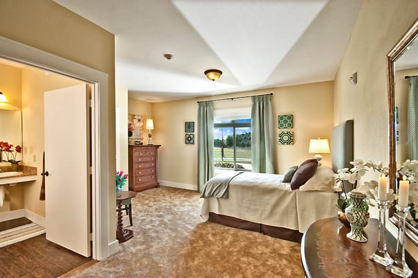 Bright and inviting bedroom with a bed, window, and dresser.