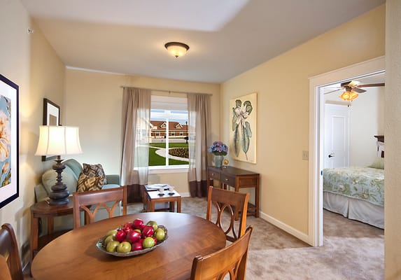 Bright living area with dining table and view of outdoor garden