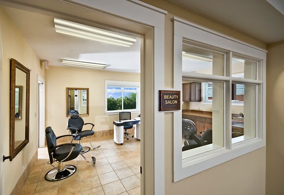 Interior view of the beauty salon with hair styling chairs and a desk