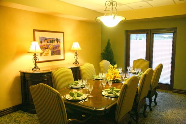 Elegantly set dining table with floral centerpiece in the dining room.