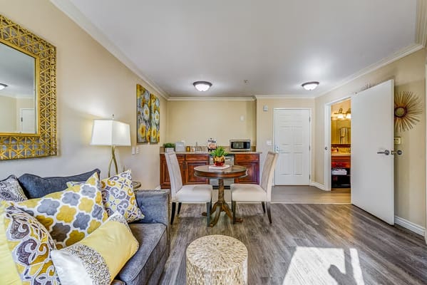 Cozy living room with dining area, bright lighting, and stylish decor