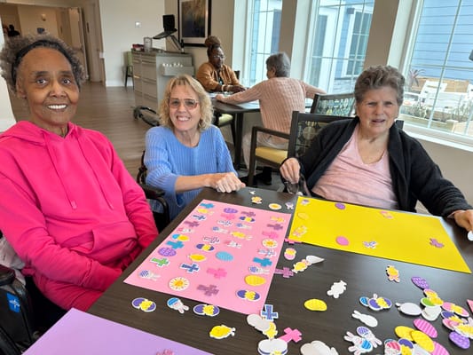 Residents engaging in a craft activity at a table