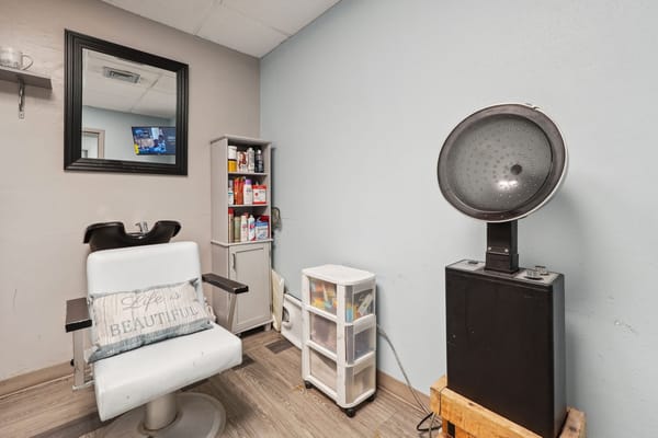 Interior of the hair salon with a stylist chair and hairdryer