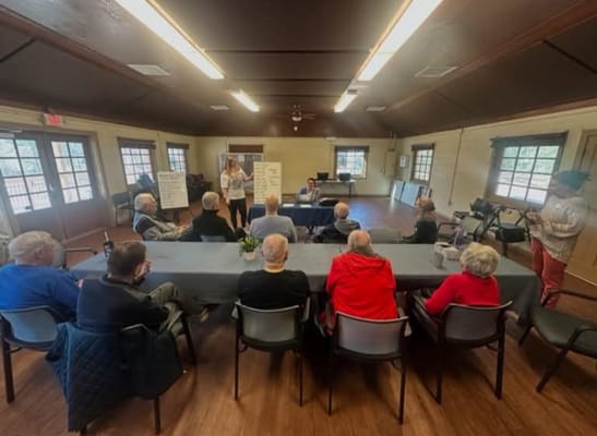 Residents participating in a group discussion in a meeting room.