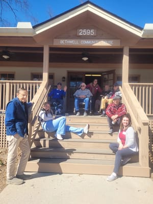 Group of seniors and staff on the steps of Bethwell Community House