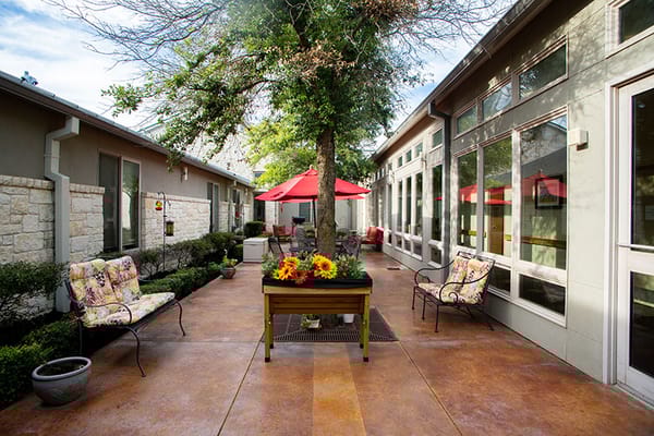 Beautiful outdoor garden area with seating and flowers.
