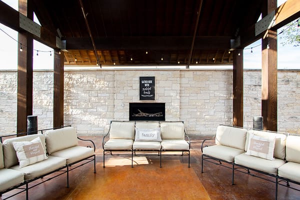 Cozy outdoor lounge with seating and a decorative wall