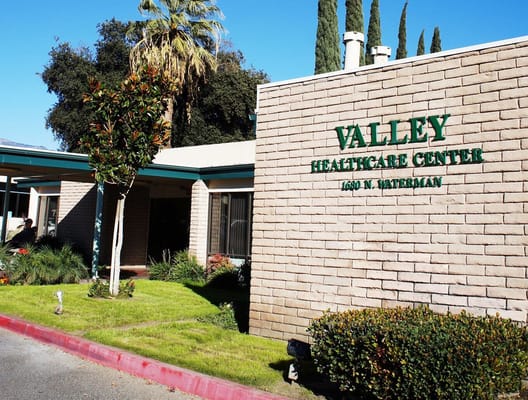 Exterior view of Valley Healthcare Center sign and landscaping