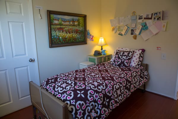 Cozy resident room with bed and artwork