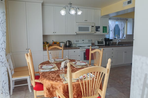 Cozy dining room set for a meal with decorative tablecloth
