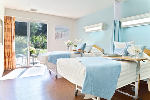 Bright and inviting bedroom with two beds and a garden view