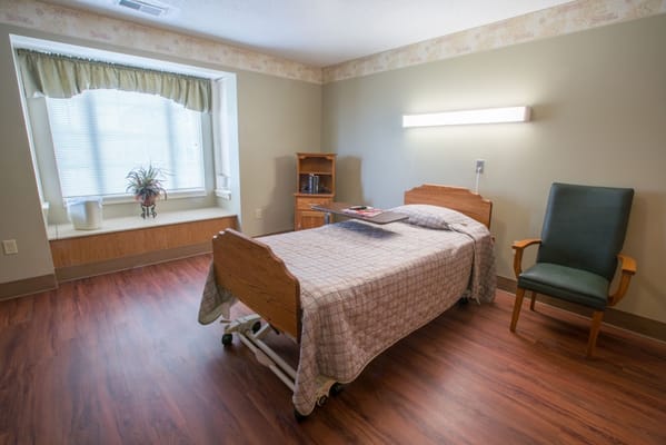 A cozy resident bedroom with natural light