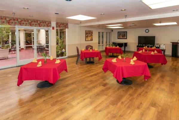 Dining room set up with red tablecloths and decorations