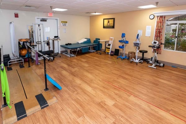 Therapy room with equipment and accessible bed