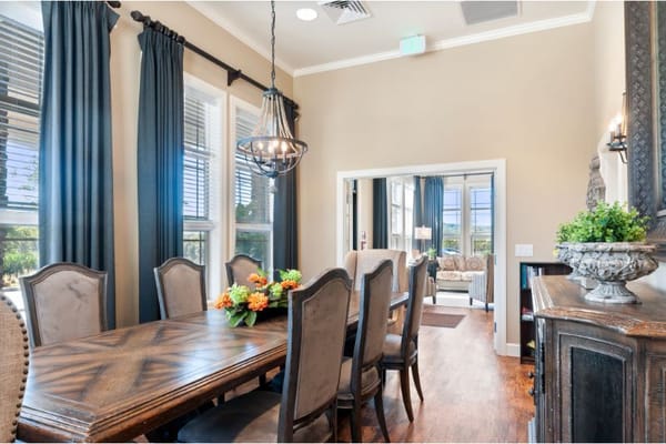 Elegant dining area with a large table and windows