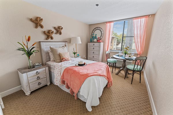 Cozy resident room with bed and dining area