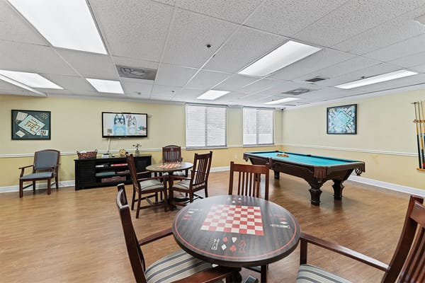 Common area with tables and a pool table