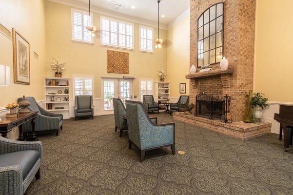Common area with seating and fireplace in a senior living facility