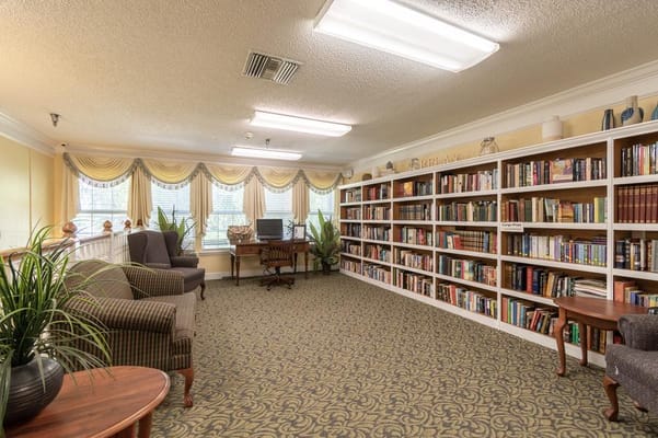 A cozy library with bookshelves and seating area