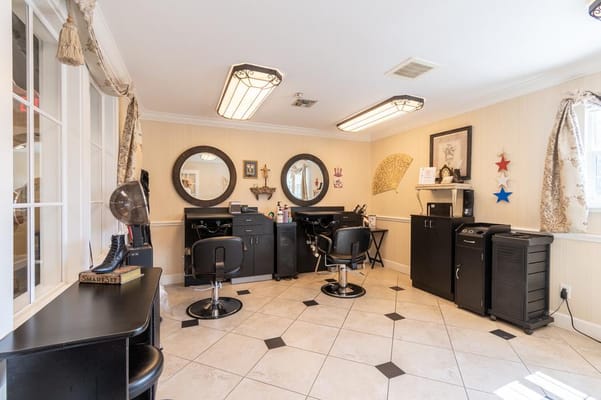 Hair salon area with styling chairs and mirrors