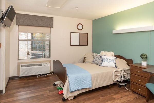 Cozy resident room with bed and window view