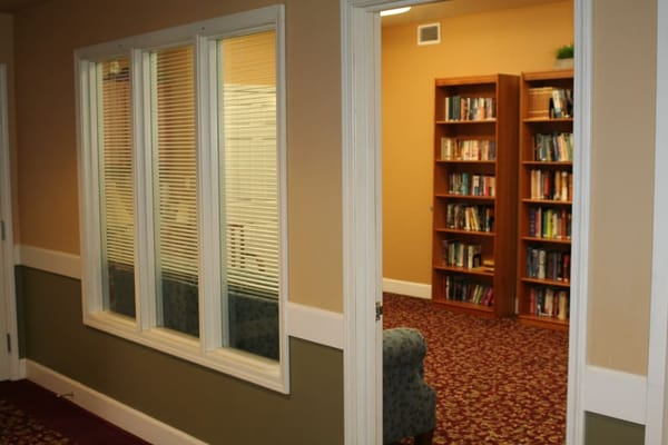 View of a hallway leading to the library with bookshelves visible