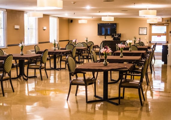 Spacious dining room with tables and floral centerpieces